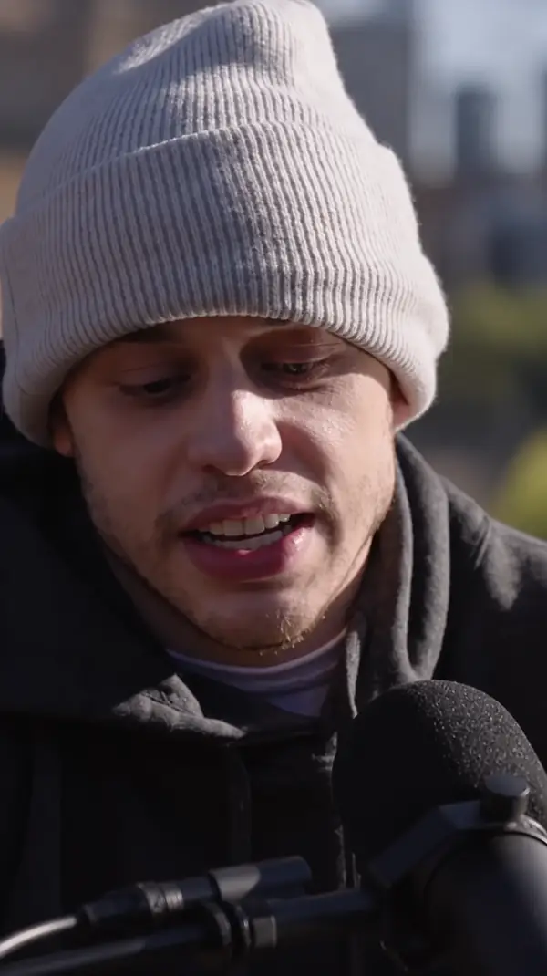 Person addressing a camera in a casual video setting